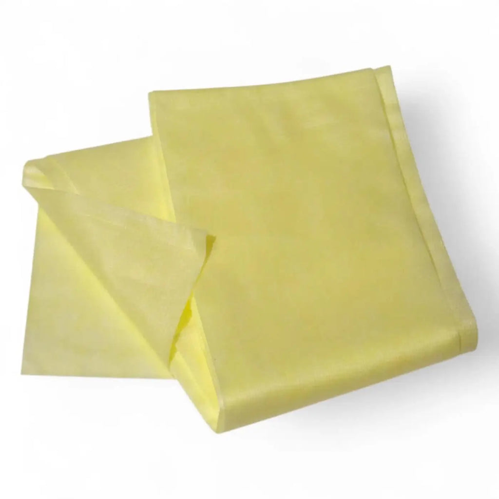 A pale yellow clendo staubbindetuch made of soft polypropylene folded neatly for dust removal