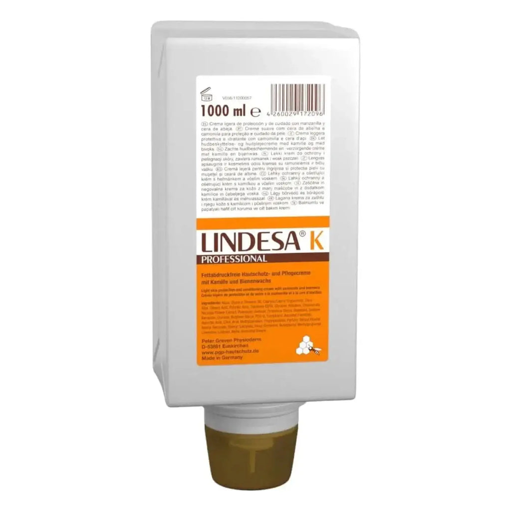 Weiße plastikquetschtube mit orange braunem etikett und markenname lindesa k professional für hautschutzcreme